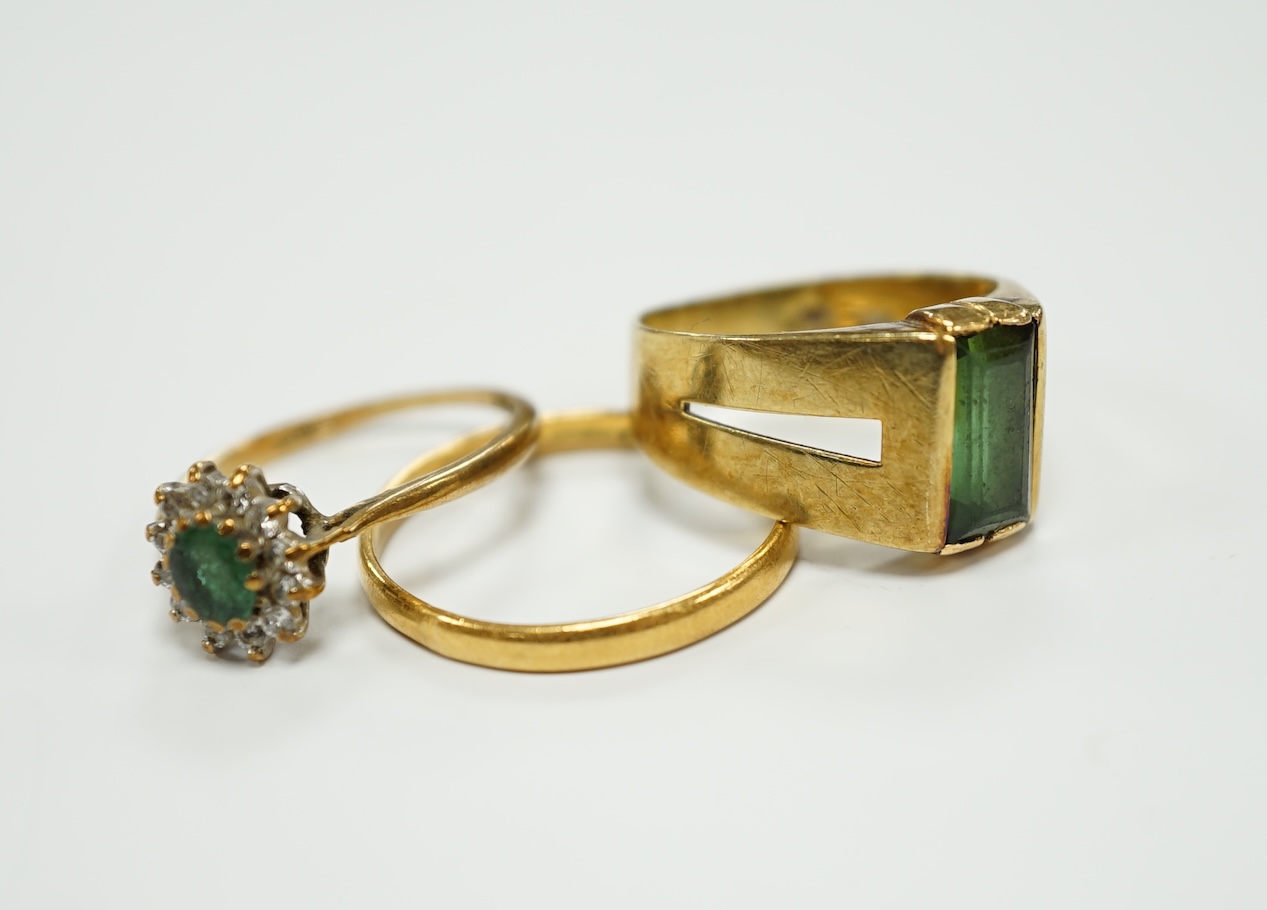A 22ct gold wedding band, 2.2 grams, an 585 and gem set ring, gross 3.5 grams and a 9ct gold an gem set ring, gross weight 1.4 grams.